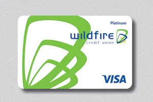 White Wildfire Credit Union Visa card with bold green design elements and blue text on a light patterned background.
