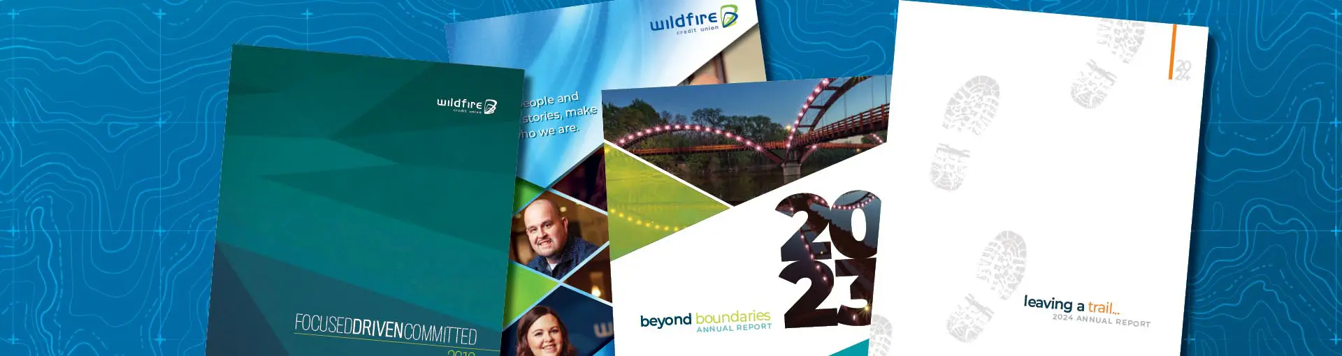 Covers of Wildfire Credit Union annual reports from various years displayed against a blue topographic background.