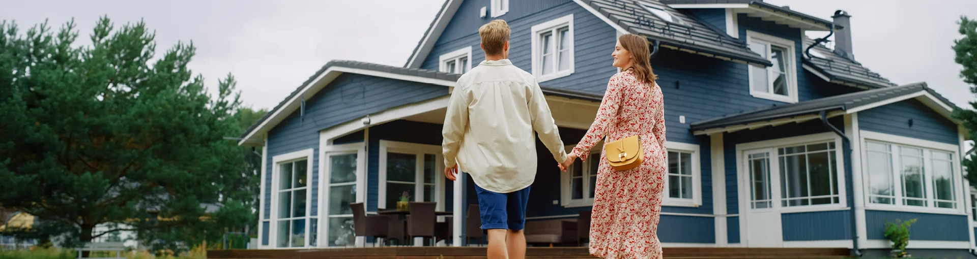 Couple standing outside of a home