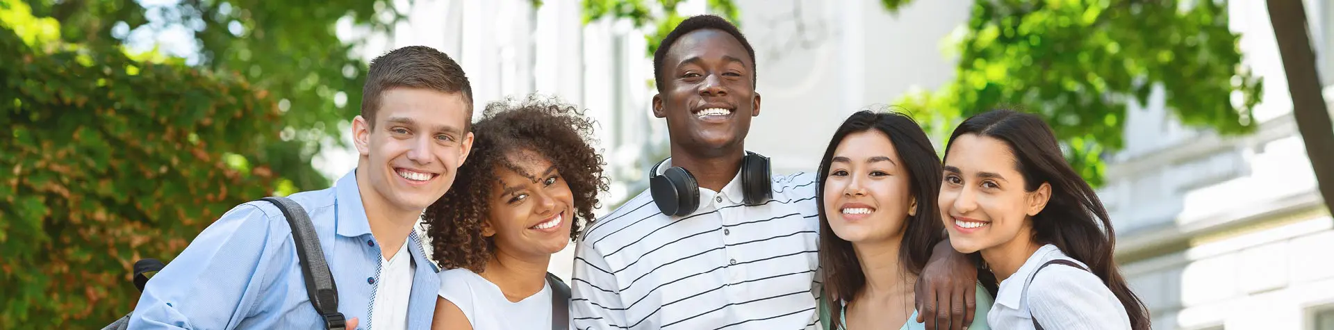 A group of young adults,  gathered outside.